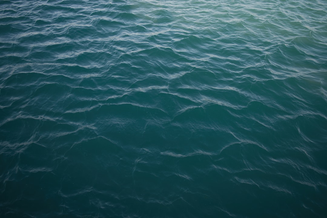 Rippling blue water surface with light reflections