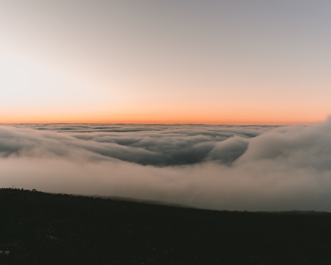 white clouds over the sea during sunset